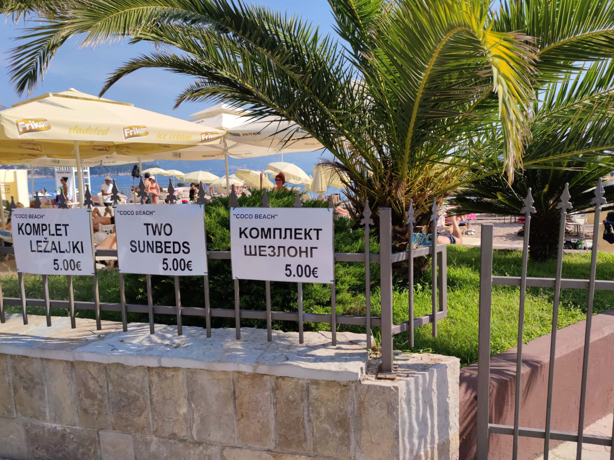 Coco Beach is a part of Slovenska Plaza in Budva. Prices for a set of 2 sun loungers and an umbrella in May 2021. Montenegro, Adriatic Sea.