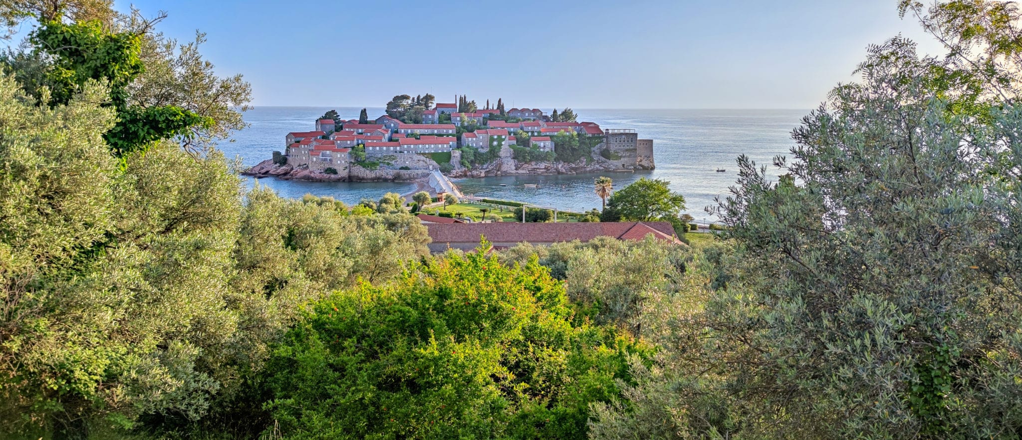 Sveti Stefan peninsula on the Budvanian Riviera in Montenegro. One of the "postcard" views of the country. View from the bushes, closer to sunset.