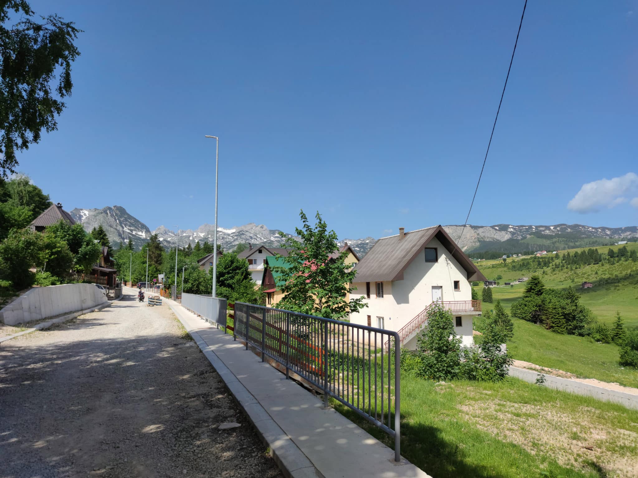 A street in the town of Zabljak in northern Montenegro in the Durmitor park. With mountains in the background.