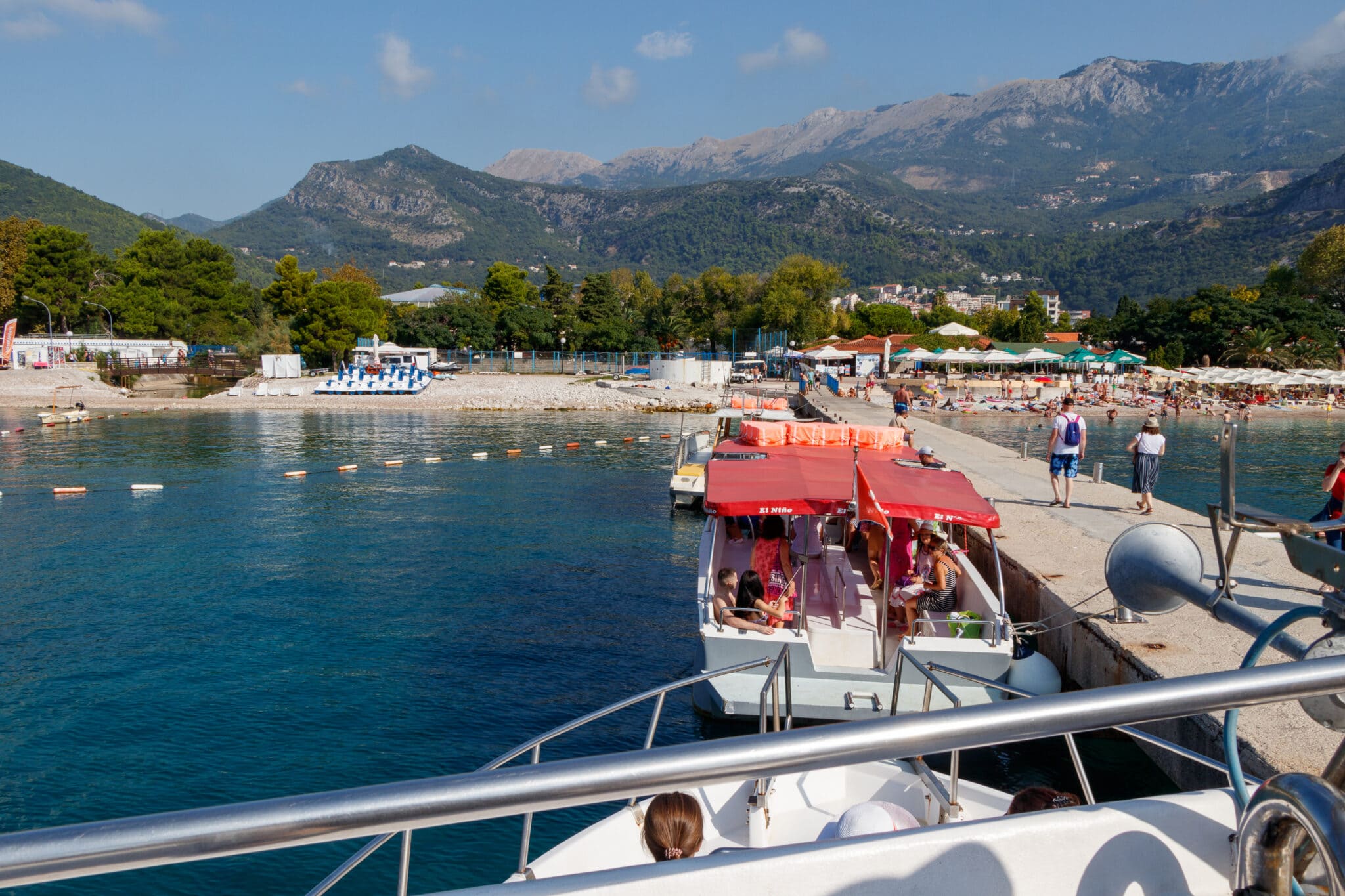 Pier on Slovenska Plaza beach in Budva. Boats depart to Hawaii Beach on the Sveti Nikola (Saint Nicholas) Island. Montenegro.