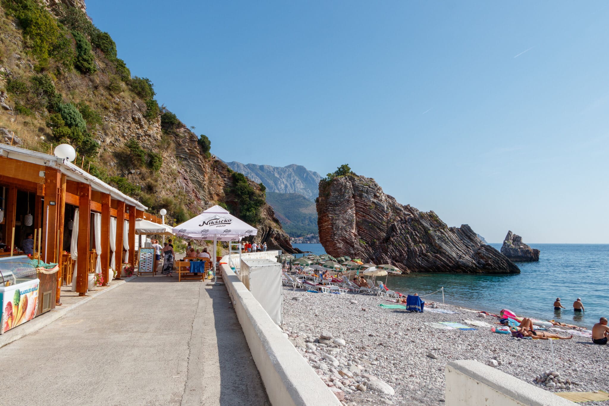 Rafailovici village. A small beach in front of the entrance to the tunnel leading to Kamenevo beach. Budva Riviera, Montenegro.